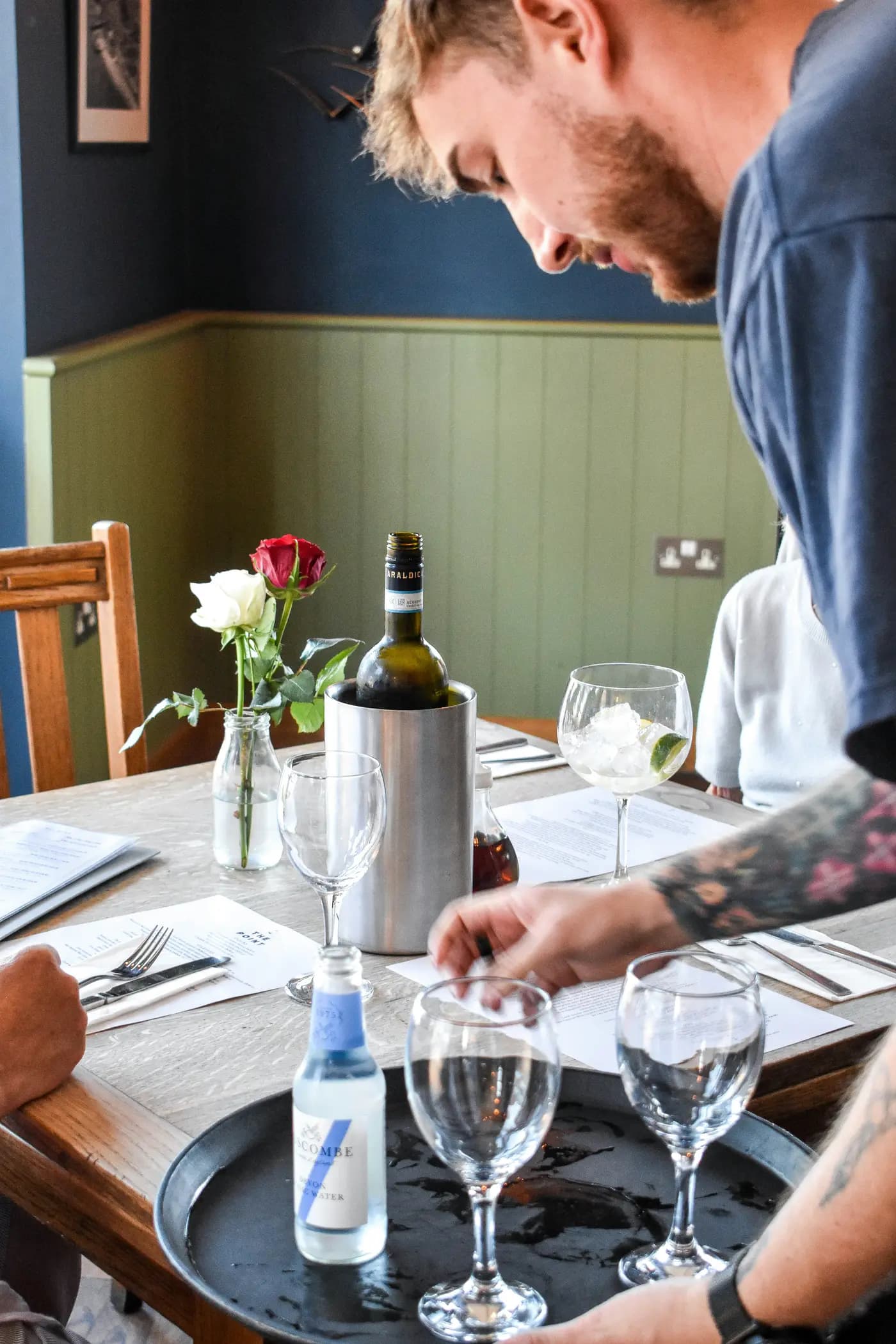 A waiter serving a table at a restaurant