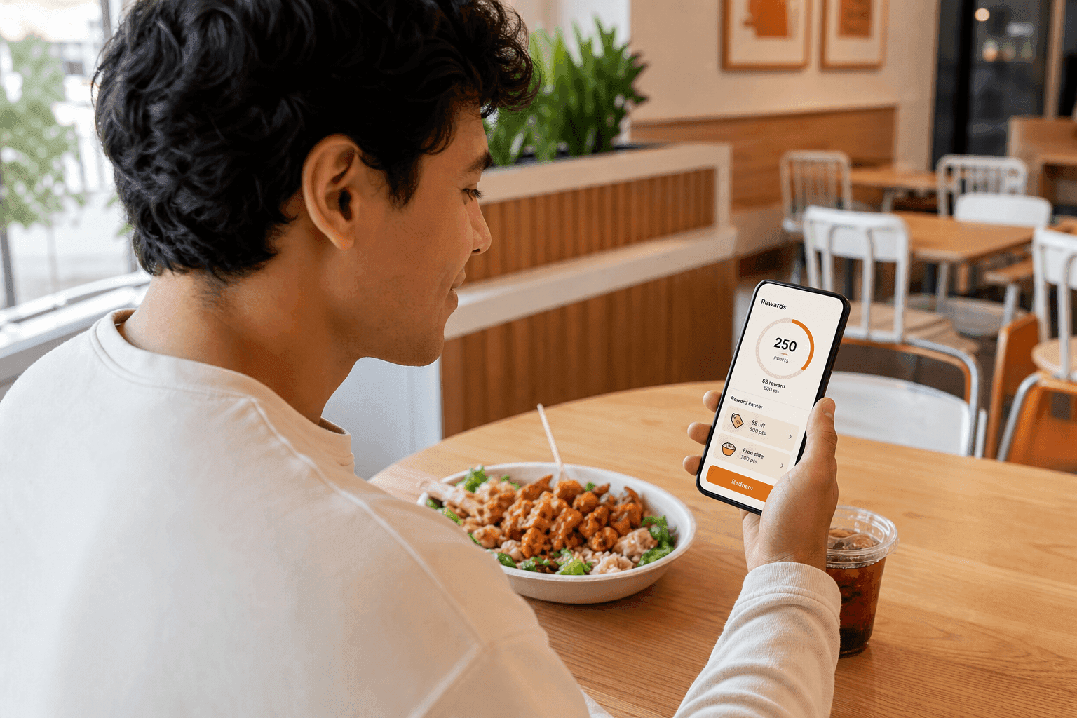 Restaurant customer viewing reward points and available rewards in a mobile app