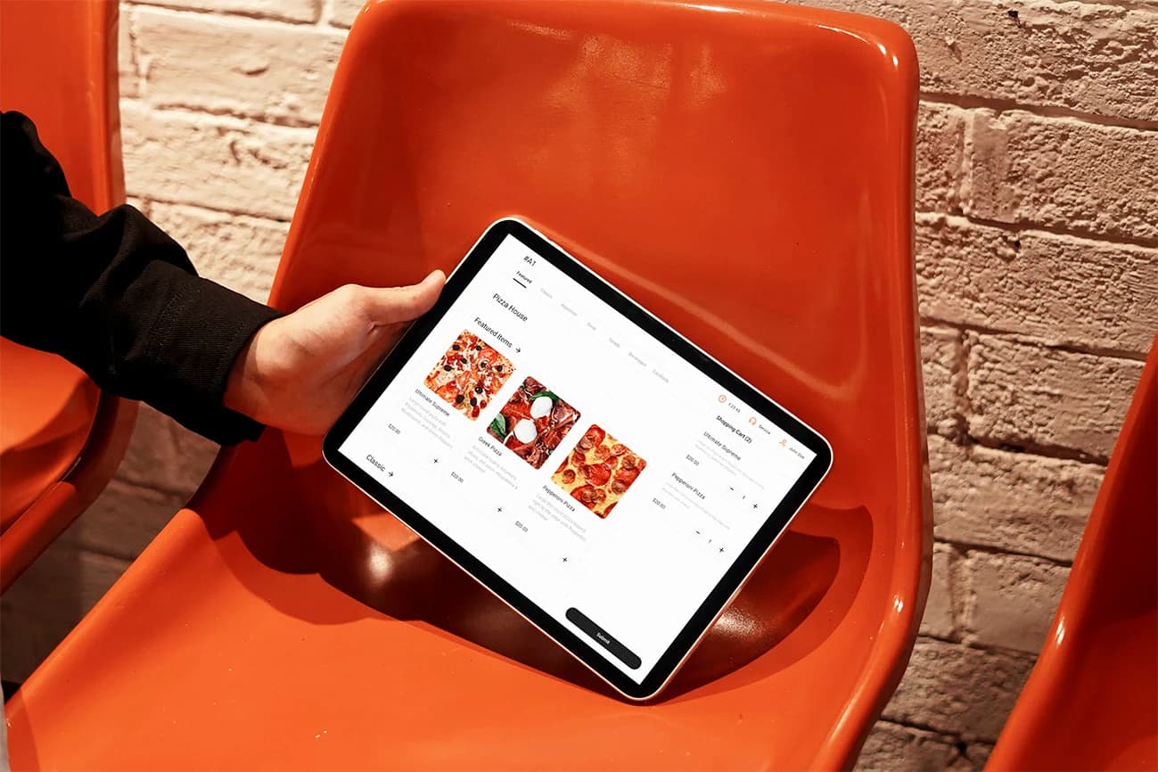 A restaurant guest browsing a digital menu on an ordering tablet