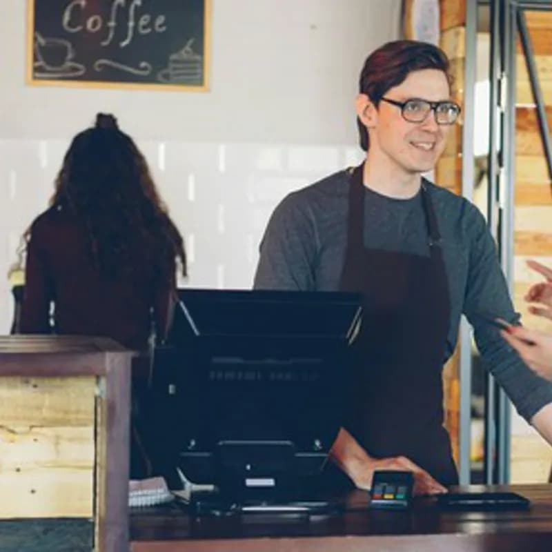 Customer pays at a coffee shop