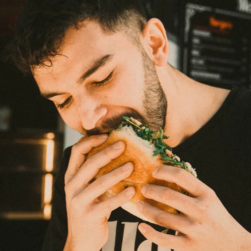 a man eating a sandwich in a restaurant