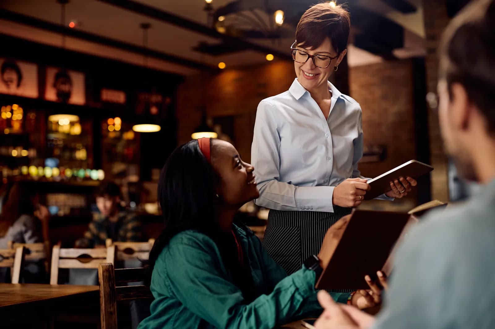 Server taking a tableside order in a restaurant